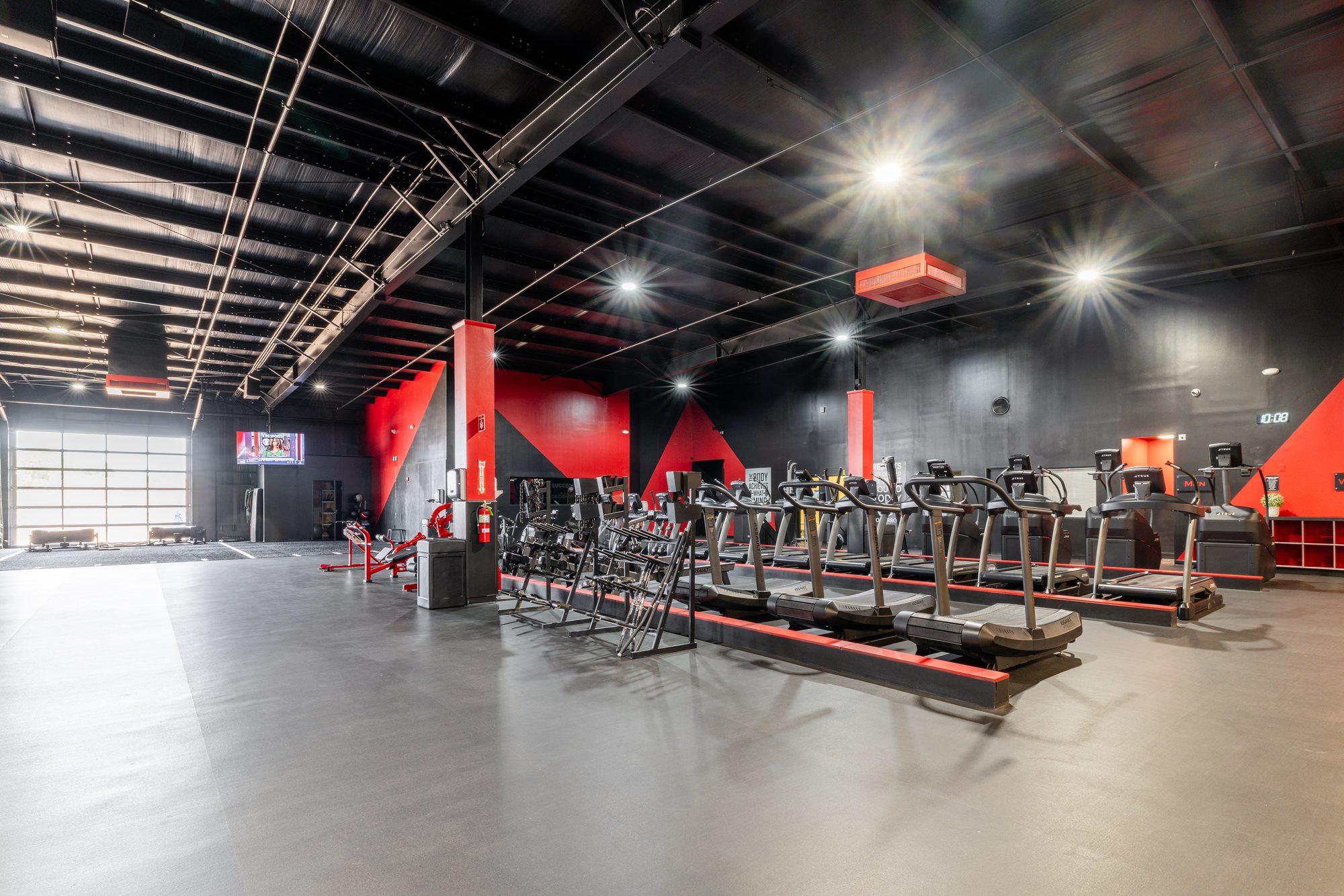Wide cinematic panoramic of TB Fitness Club full fitness floor showing the scale of the facility
