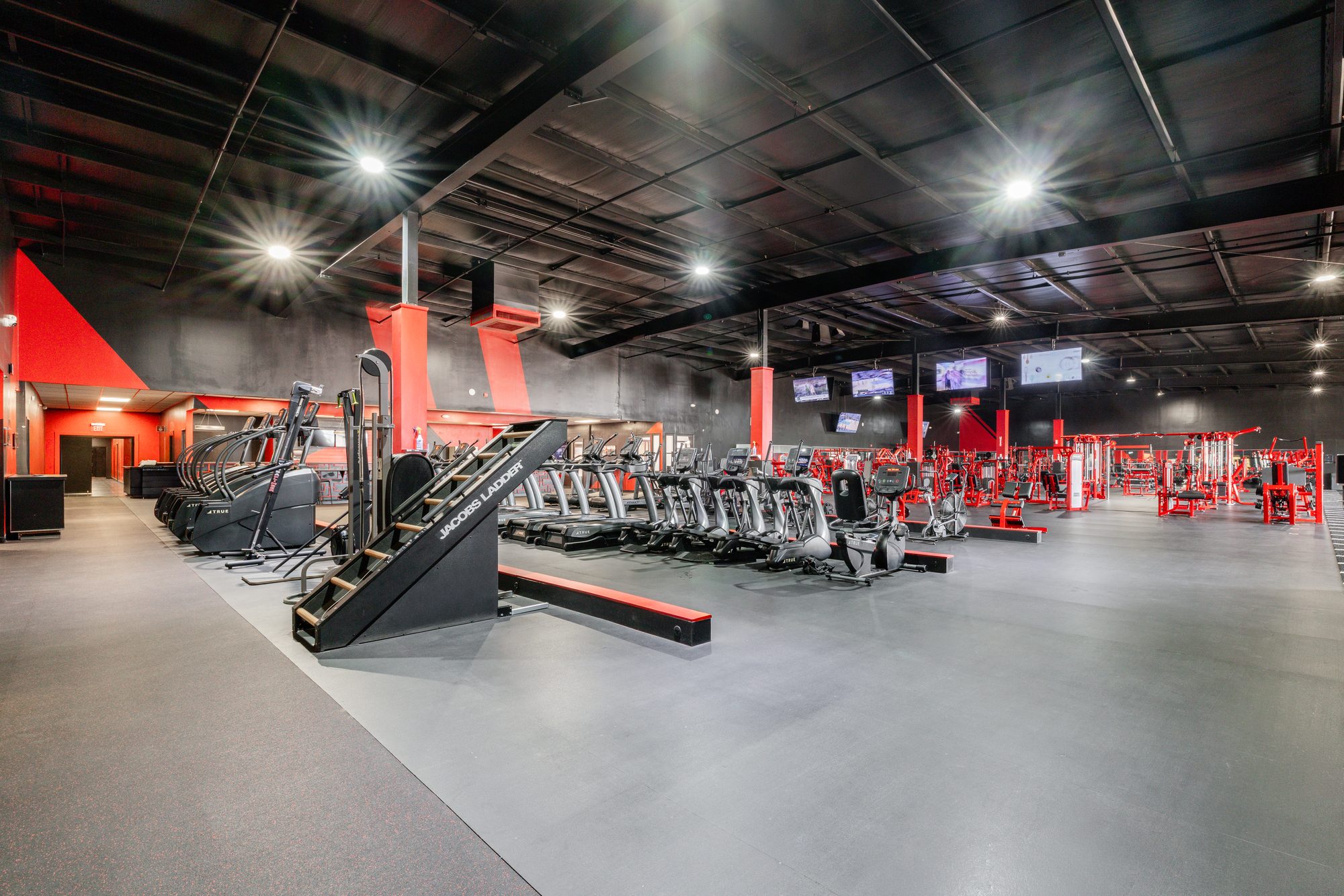 TB Fitness Club strength training area with red Hammer Strength machines